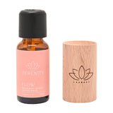 Flow Lotus Wood Block Diffuser with amber oil bottle, natural pale wooden cylinder engraved with lotus motif and black dropper cap, on a plain white background.