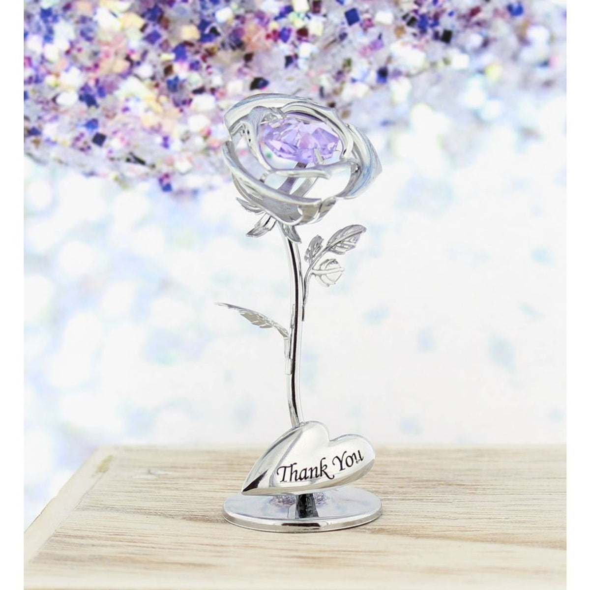 Silver metal rose figurine with faceted lilac crystal centre, veined leaves, and a heart-shaped plaque reading "Thank You" on a round base.