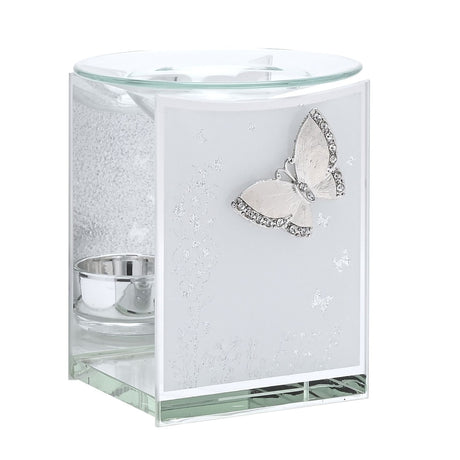 Rectangular glass wax melt burner with a white front panel, silver glitter-edged butterfly and floral accents, mirrored base, and a clear glass dish on top, shown on a plain white background.