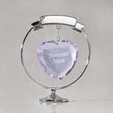 Chrome plated circle and heart decoration with a faceted lilac crystal heart engraved "Special Nan" hanging within a silver ring on a round base, plain light background.
