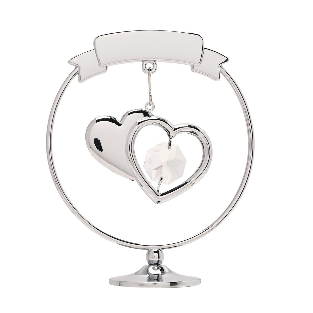 Chrome circle decoration with a curved "25th Anniversary" ribbon banner, two overlapping hearts holding a clear faceted crystal, set on a round silver pedestal base against a plain white background.