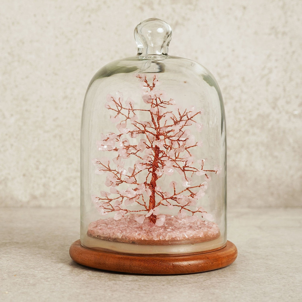 Gemstone Dome Tree figurine with copper wire branches and 200 pink gemstone beads, set on a pink crystal base under a glass dome with a round wooden stand.