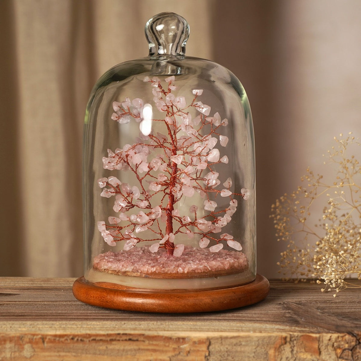 Gemstone Dome Tree figurine with pink gemstone beads on copper-coloured wire branches, chip-stone base, and arched glass dome on a round wooden stand.