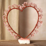 Rose Quartz Heart Tree Figurine with wire branches shaped into an open heart, pink crystal chip clusters on copper-toned wire, set on a rough quartz base.
