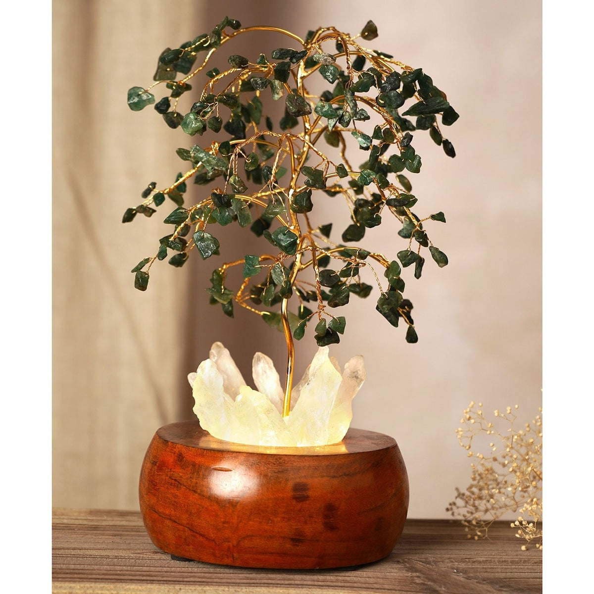 Aventurine LED glow tree decoration with gold wire branches holding green chip leaves over a glowing white crystal cluster set in a round brown wooden base.
