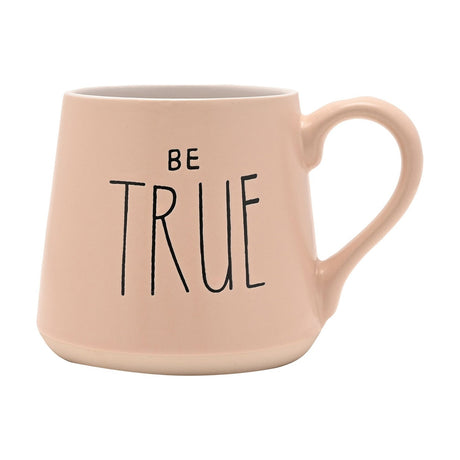Pink tapered earthenware mug with "BE TRUE" in black lettering, white interior, and a bare sandy-clay band at the base, shown on a plain white background.