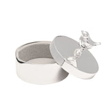 Silverplated round trinket box with a robin perched on the lid as its handle, shown open to reveal a soft grey lining, on a plain white background.