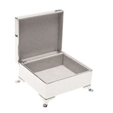 Silverplated rectangular trinket box with a hinged lid open to reveal a grey lined interior, standing on four small ball feet against a plain white background.