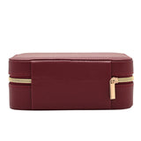 Medium rectangular jewellery box in red pebbled-texture plastic, shown closed with gold-tone zip and fabric pull tab, on a plain white background.