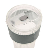 Close-up of the ribbed cold drink tumbler's clear lid with sliding closure and straw slot, showing the fluted clear body and grey sleeve, on a plain white background.