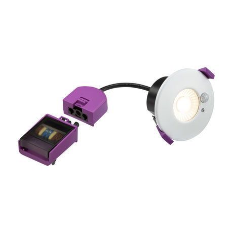 SpektroLED Evo 7W Fire Rated PIR Downlight in white steel, round fixture with integrated motion sensor and LED lit warm white, shown with purple driver and connector on a plain white background.