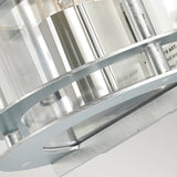 The image features a close-up of a cylindrical structure crafted from galvanized steel and equipped with transparent sections, showcasing industrial elements and engraved text. This IP54-rated depiction highlights the intricate details of the Stockholm Outdoor 1 Light Flush Light in silver with clear glass against a light background.