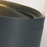 Close-up image of the Stavanger LED Small Bollard in Graphite, featuring a transparent container with a dark base, perfect for outdoor lighting. Inside, layered black elements capture attention. Its modern design is vandal-resistant and seamlessly integrates the transparent top with the solid dark bottom—ideal for this LED Small Bollard setup.