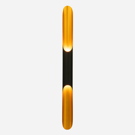 Introducing the Stealth 2 Light Wall Light - Gold & Black: featuring a sleek, modern design with a long, narrow silhouette adorned with gold accents at both ends. This sophisticated fixture casts a warm, inviting glow against any gold interior, enhancing your space with elegance.