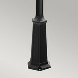 The Turin 3 Light Triple Lamp Post - Black, featuring an octagonal base with engraved panels and a smooth finish, stands gracefully against a plain grey background—perfect for enhancing garden illumination or as part of elegant outdoor lighting.