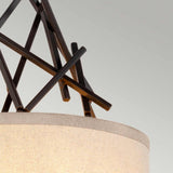 Close-up of a modern wall light with overlapping metal rods forming a geometric design above two cylindrical beige lampshades, embodying the charm of decorative lighting in an Olde Bronze finish, known as the Taiko 2 Light Wall Light.