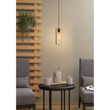 Tarnenne wooden pendant light with a rectangular wood frame and black steel E27 lampholder, hung on a black cord above a side table in a living room setting.