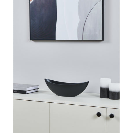 Tazeyol Planter 11cm in matt black, a low boat-shaped oval decor piece displayed on a white sideboard beside books and candles.