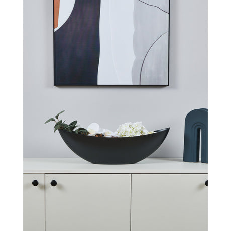 Tazeyol Planter 17.5cm in matt black, long boat-shaped design holding greenery and white flowers, styled on a white sideboard beneath framed wall art.