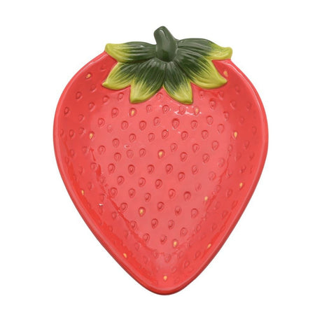 Strawberry-shaped red stoneware plate with raised seed texture and a sculpted green leaf and stalk design, shown on a plain white background.