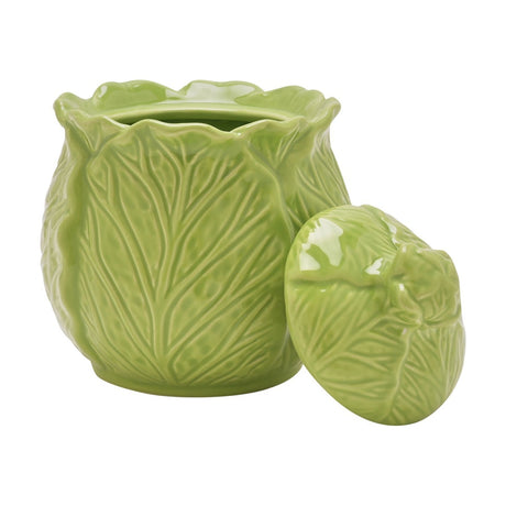 Green glazed stoneware sugar bowl shaped as a cabbage head, with relief leaf veining, a wavy rim, and a rounded leaf-textured lid shown beside it on a plain white background.