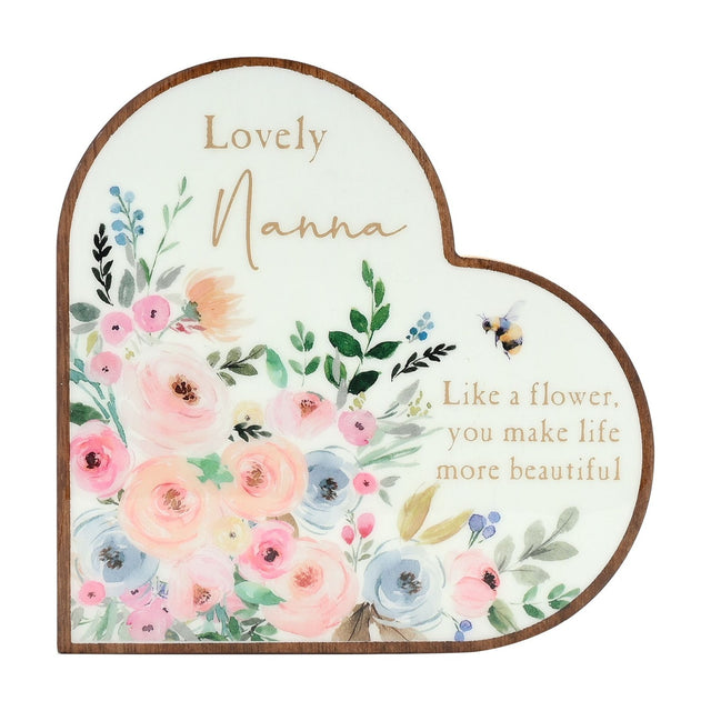 Wooden heart-shaped mantel plaque in white with pastel pink, peach and blue florals, "Lovely Nanna" text and a bee detail, shown on a plain background.