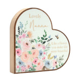 Wooden heart-shaped plaque reads Lovely Nanna, Like a flower, you make life more beautiful, surrounded by pastel pink, peach and blue florals on a white face.