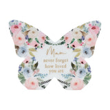 White wooden butterfly mantel decoration with pastel pink, blue and cream floral design and gold "Mam never forget how loved you are" text, on a plain background.