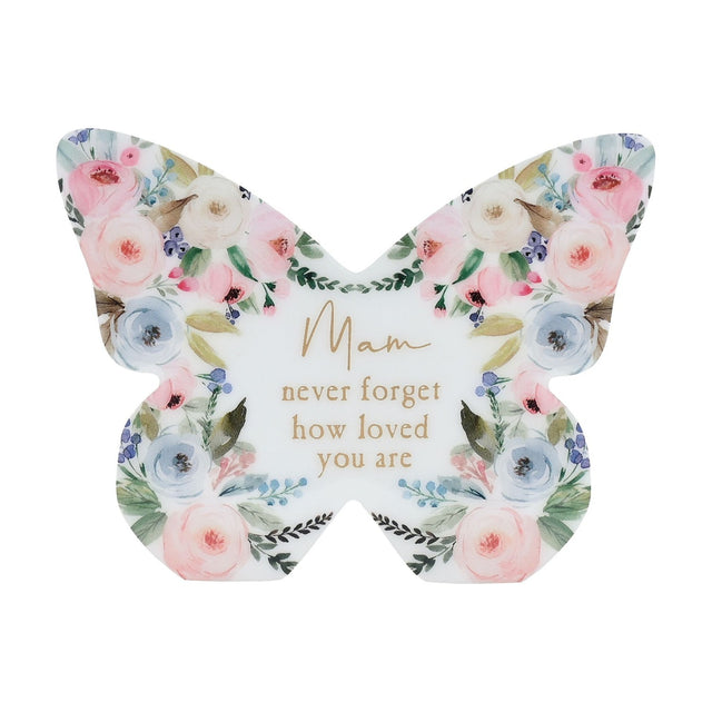 White wooden butterfly mantel decoration with pastel pink, blue and cream floral design and gold "Mam never forget how loved you are" text, on a plain background.