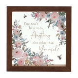 Square glass plaque in a brown frame, with pink and blue watercolour-style flowers, two bees, and gold text reading "You don't have to be Anything else other than Yourself".