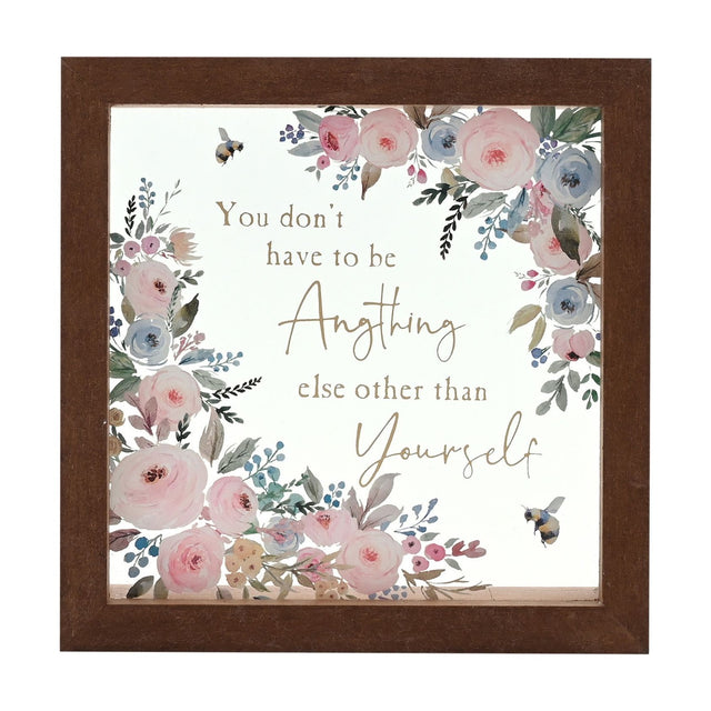Square glass plaque in a brown frame, with pink and blue watercolour-style flowers, two bees, and gold text reading "You don't have to be Anything else other than Yourself".