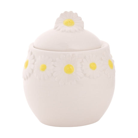 Daisy Stoneware Sugar Bowl with Lid in white ceramic, featuring a round belly shape, raised daisy band with yellow centres, and a daisy-shaped lid knob, on a plain white background.