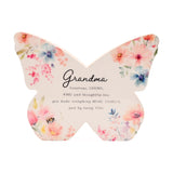 White wooden butterfly-shaped mantel decoration with pastel floral print in pink, peach and blue, a small bee detail, and a Grandma verse in script text.