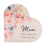 White wooden heart-shaped mini plaque with pastel watercolour florals and a bee, reading "Mum, Never forget how LOVED you are" in black script, on a plain background.