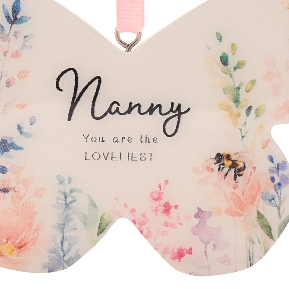 Wooden butterfly-shaped hanging decoration in white, printed with watercolour wildflowers and a bee, reading "Nanny You are the LOVELIEST" with a pink ribbon loop.