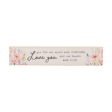 Cream wooden wall plaque reading Love you and you fill our world with SUNSHINE and our hearts with LOVE, flanked by peach, coral and lilac watercolour wildflowers, on a white background.