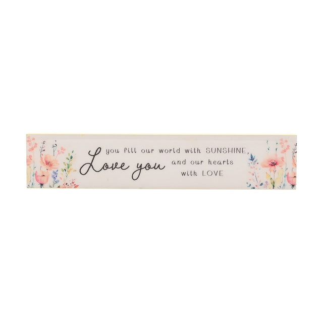 Cream wooden wall plaque reading Love you and you fill our world with SUNSHINE and our hearts with LOVE, flanked by peach, coral and lilac watercolour wildflowers, on a white background.