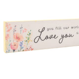 Skinny wooden wall plaque in cream and yellow, featuring watercolour wildflowers in peach, coral and lilac beside "Love you" in black script text, shown on a white background.
