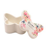 White butterfly-shaped glass trinket box with lift-off floral lid, "Grandma, Never forget how LOVED you are" text, shown open on plain white background.