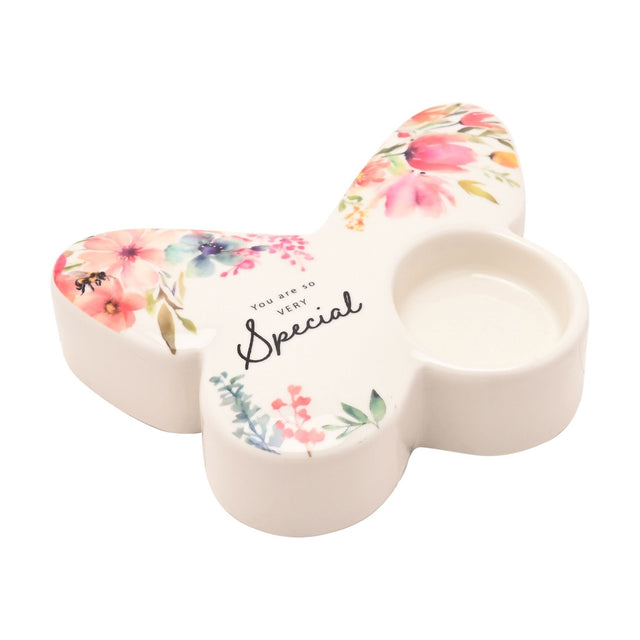 White glass butterfly-shaped tealight candle holder with floral watercolour design, a bee motif, and "You are so VERY Special" script, on a plain white background.