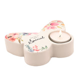 White glass butterfly-shaped tealight candle holder with floral watercolour design, "You are so VERY Special" text, and a lit tealight, on a plain white background.