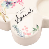 White glass butterfly tealight candle holder with "You are so VERY Special" script, watercolour floral wing details and a round tealight recess.