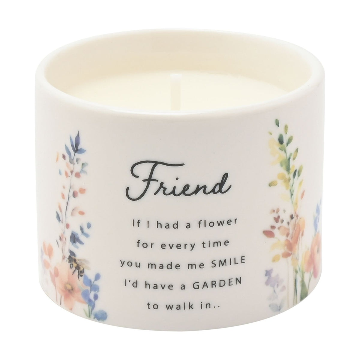 Round ceramic scented candle in off-white with watercolour wildflower prints and "Friend" script with sentimental verse, white wick visible, shown on a plain background.