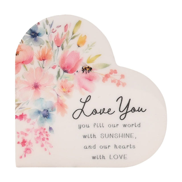 White heart-shaped wooden plaque with a watercolor floral bouquet and bee, reading Love You, you fill our world with SUNSHINE, and our hearts with LOVE.
