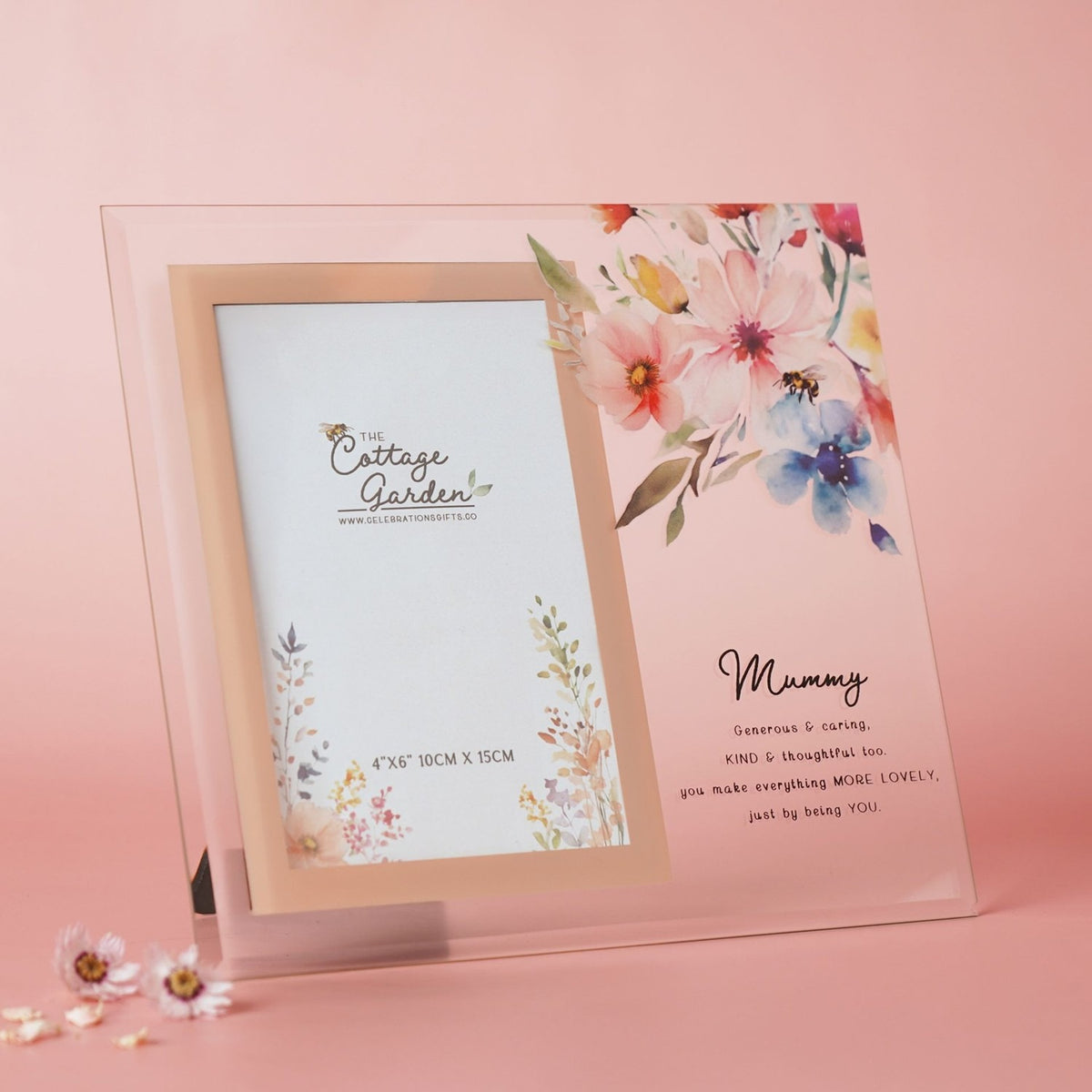 Rectangular clear glass photo frame with rose-gold inner border, featuring a watercolour floral spray and "Mummy" verse, holding a 4x6" sample photo, set against a pink background.