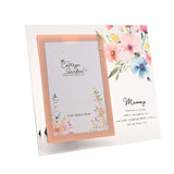 Glass photo frame for a 4"x6" photo with clear front, rose-gold inner border, watercolour floral corner design, and "Mummy" verse text, shown on a white background.
