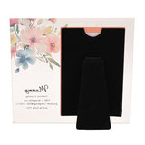 Glass photo frame with watercolour floral corner design and a bee, "Mummy" script and verse printed below, shown with black velvet easel stand on a plain background.