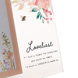 Loveliest Floral Bee freestanding glass photo frame with a peach-pink border, watercolour florals, a bee motif, and "Loveliest" script with verse text, pictured in close-up.