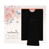 Loveliest Floral Bee Freestanding Glass Photo Frame in pink, with a watercolour floral and bee design, black velvet easel back, and "Loveliest" script text, shown on a plain white background.