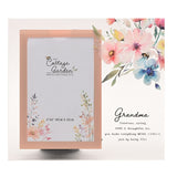 Clear glass photo frame with peach-bordered 6 x 4in opening, watercolour floral and bee design, and script "Grandma" verse beside the picture space.